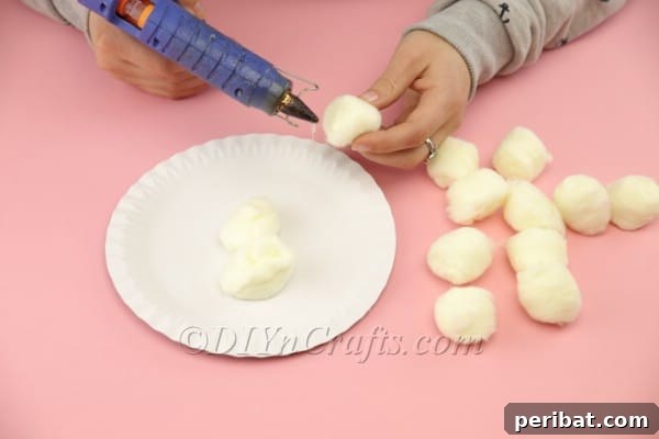 Fluffy Paper Plate Easter Sheep Craft 8 Applying cotton balls to cover the paper plate
