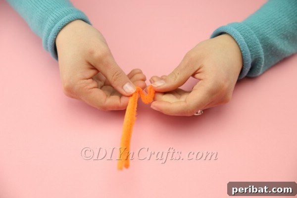 Craft Adorable Pom-Pom Easter Chicks at Home 13 Twisting pipe cleaner to form a chick's foot with toes