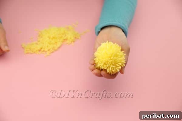 Craft Adorable Pom-Pom Easter Chicks at Home 9 Trimming and shaping loose yarn ends for pom-pom