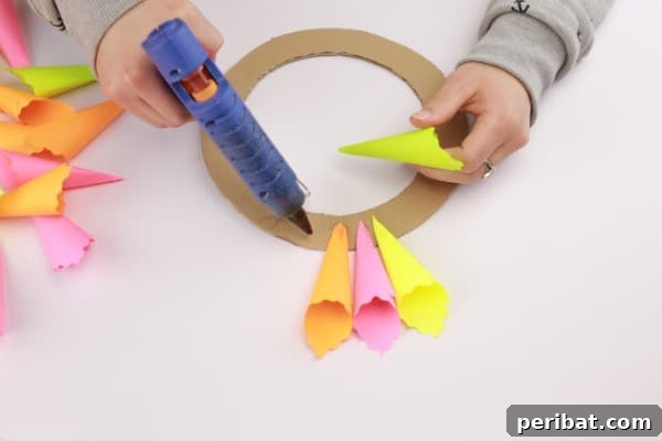 Transform Sticky Notes into a Vibrant Easter Wreath 11 Using hot glue to attach the folded sticky notes - First layer application