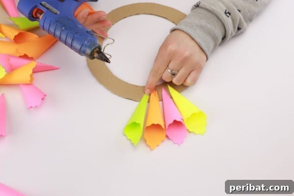 Transform Sticky Notes into a Vibrant Easter Wreath 12 Using hot glue to attach the folded sticky notes - Progress on first layer