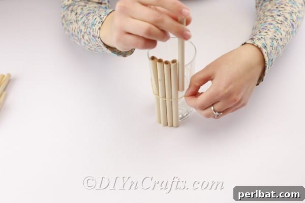 Rustic Easter Centerpiece: An Old Book's New Chapter 10 Adding the rolled book pages to the vase under the rubber band.