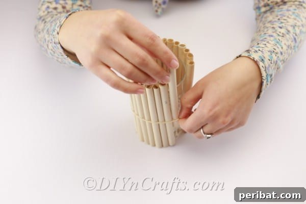 Continuously adding book page rolls to cover the vase.