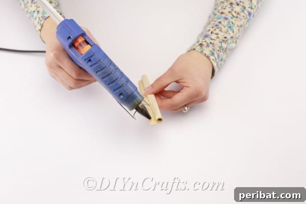 Applying glue to fix the rolled book page shape.