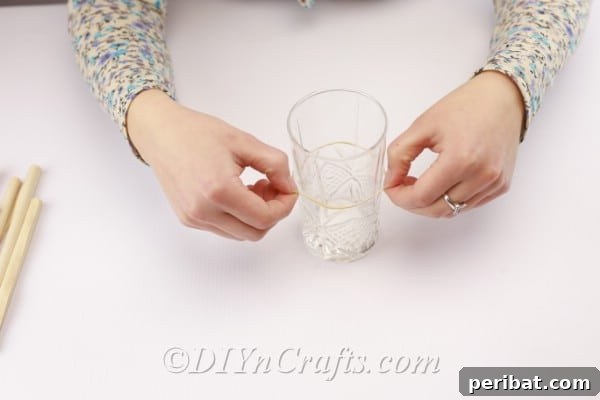 Attaching a rubber band to the vase for holding pages.