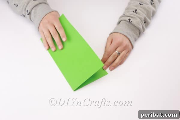 Folding the paper in half.