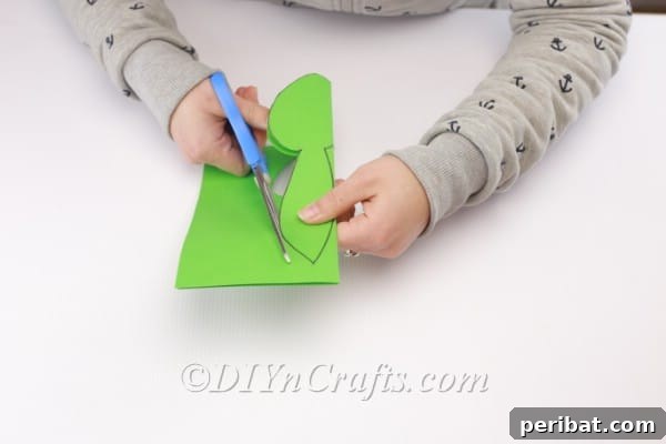 Craft a Charming Paper Easter Bunny 8 Cutting the drawn head shape.