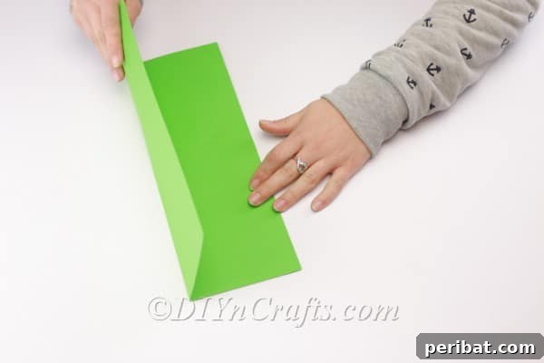 Folding the second shape of construction paper.