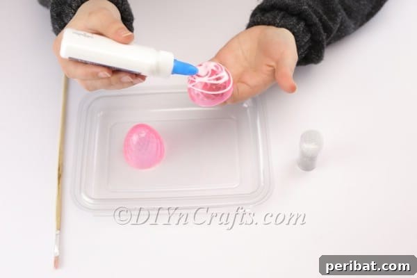 Transform Your Plastic Eggs: Easter Decor DIY 5 Applying glue to the plastic Easter egg.