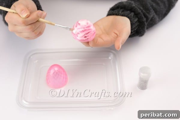 Transform Your Plastic Eggs: Easter Decor DIY 6 Evening out the glue with a paintbrush.