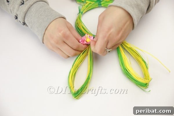 Craft an Adorable Bunny Easter Wreath 15 Decorating the bunny wreath with artificial flowers and a bow for Easter, showcasing creative embellishment.