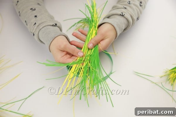 Craft an Adorable Bunny Easter Wreath 6 Tying together the first bundle of shredded paper with a ribbon for the bunny's body.