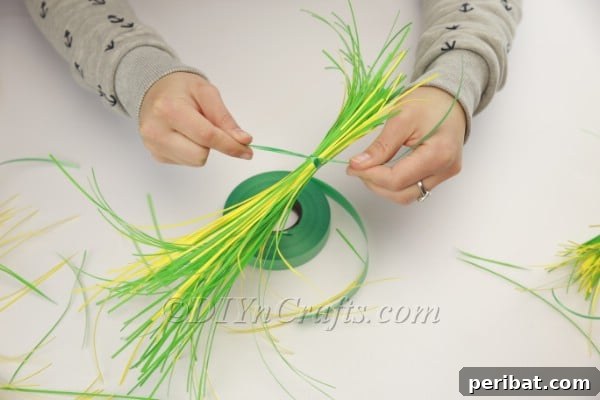 Craft an Adorable Bunny Easter Wreath 7 Close-up of the securely tied shredded paper bundle, showing the mixed colors.