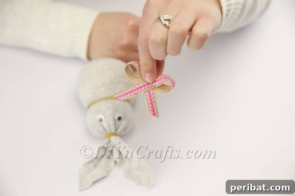Attaching a cute bow to the bunny's neck.
