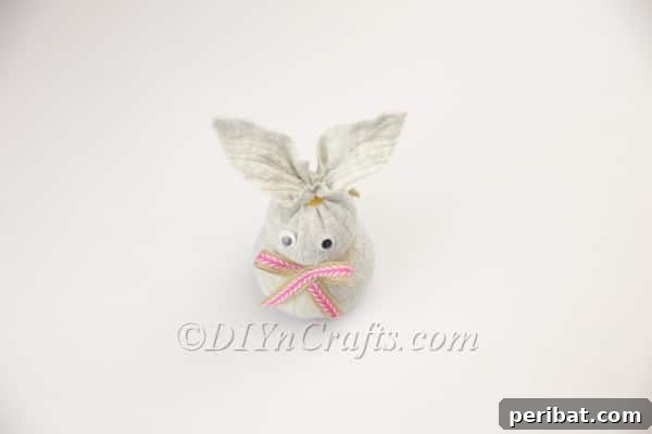 Attaching a cute bow to the bunny's neck.