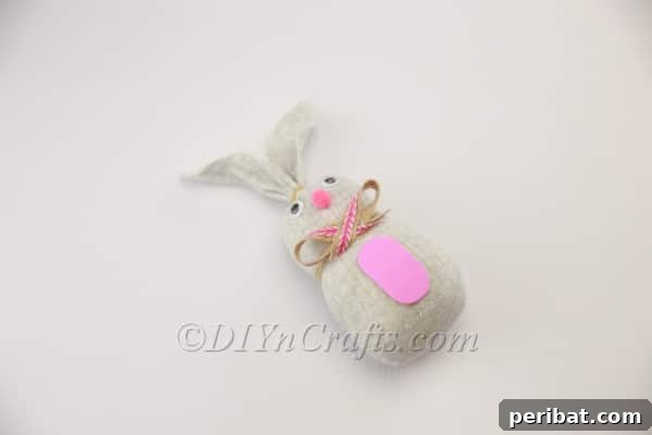 Gluing the pink pom-pom bunny nose.