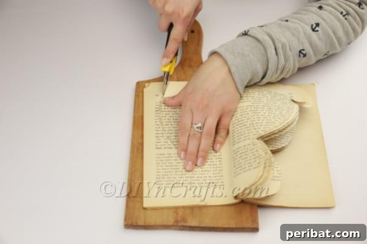 DIY Easter Bunny From a Repurposed Book 10 Carefully cutting the bunny's feet shape into the pages.