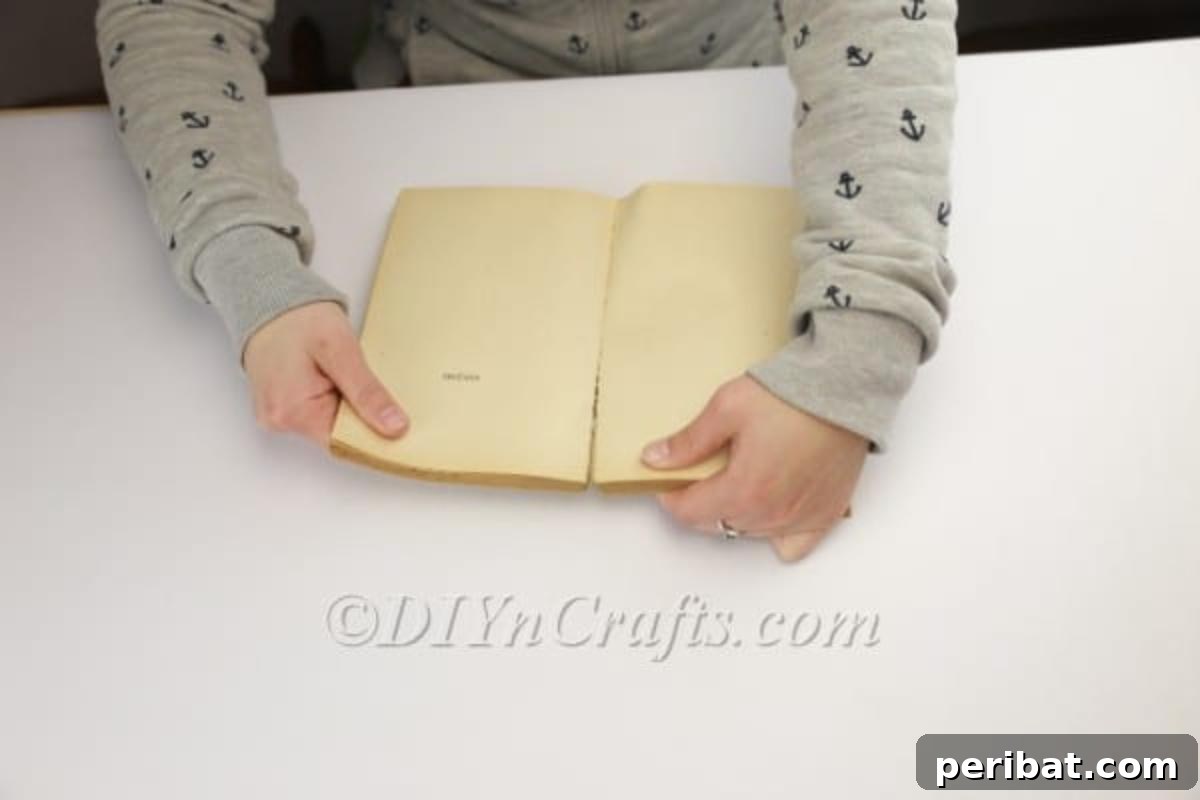 DIY Easter Bunny From a Repurposed Book 4 Preparing the old book for crafting by separating the binding.
