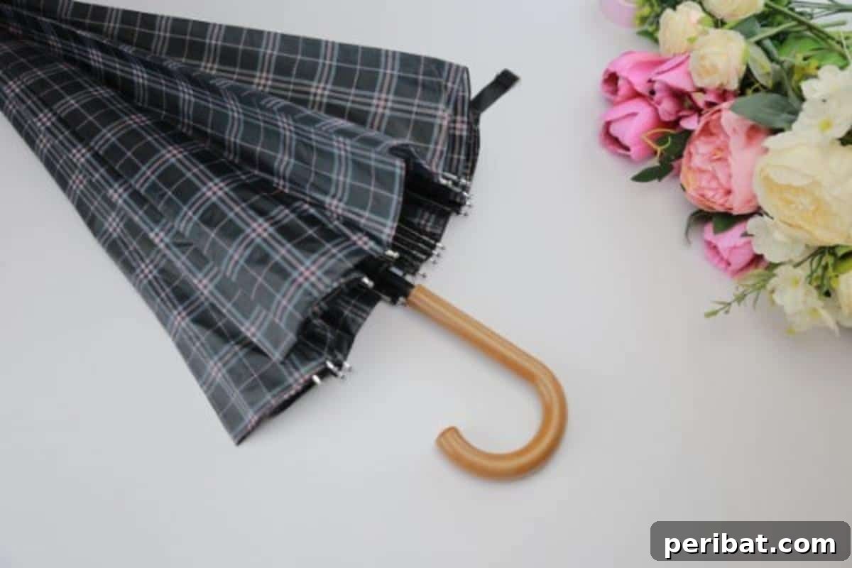 Prepare the umbrella by releasing the clasp for the DIY spring flower arrangement.