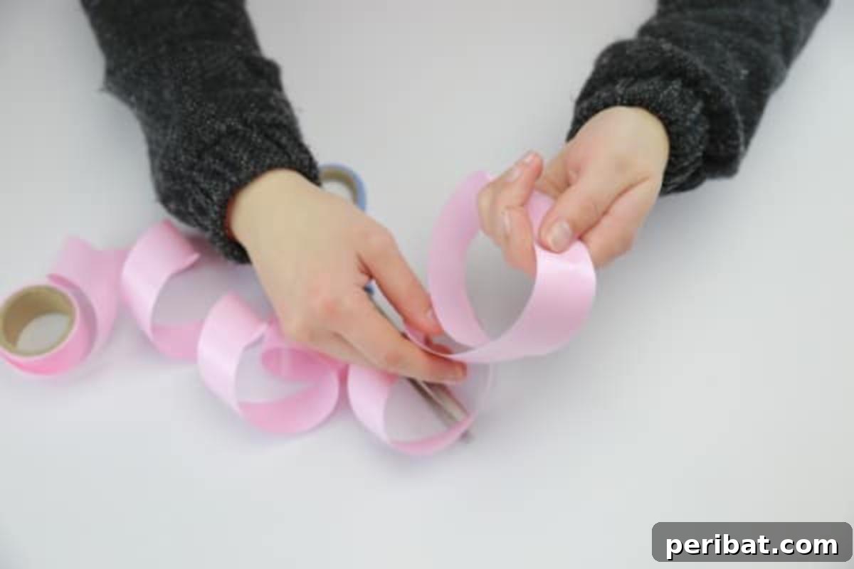 Creating a decorative bow by spooling ribbon around your hand.