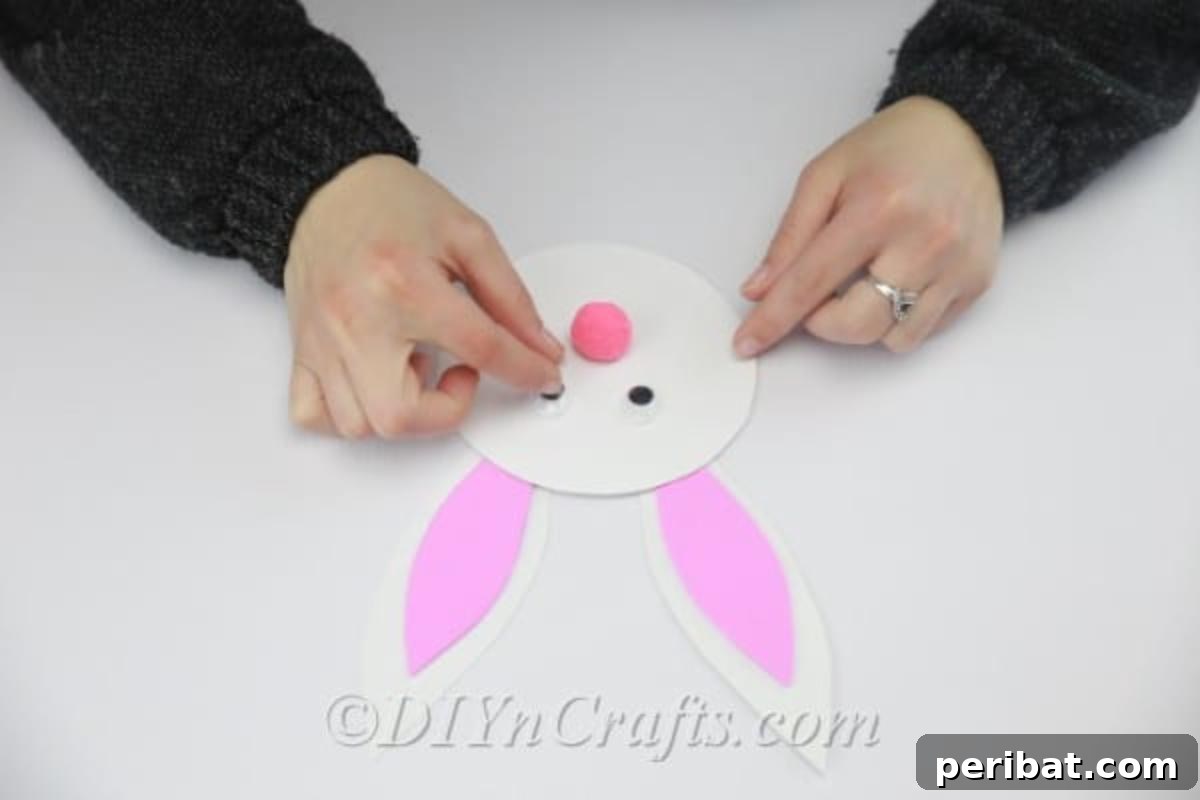 Craft an Adorable Easter Bunny from a Repurposed Party Ball 11 Glue the googly eyes to the bunny's face.