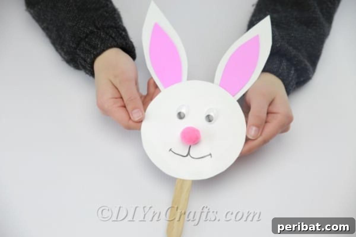 Craft an Adorable Easter Bunny from a Repurposed Party Ball 13 Glue a Popsicle or craft stick onto the bunny's neck.