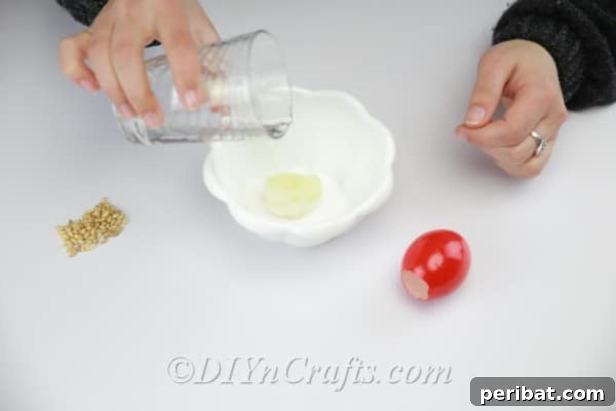 Hatch a DIY Easter Egg Planter 13 Filling the decorated empty eggshell with wet cotton.