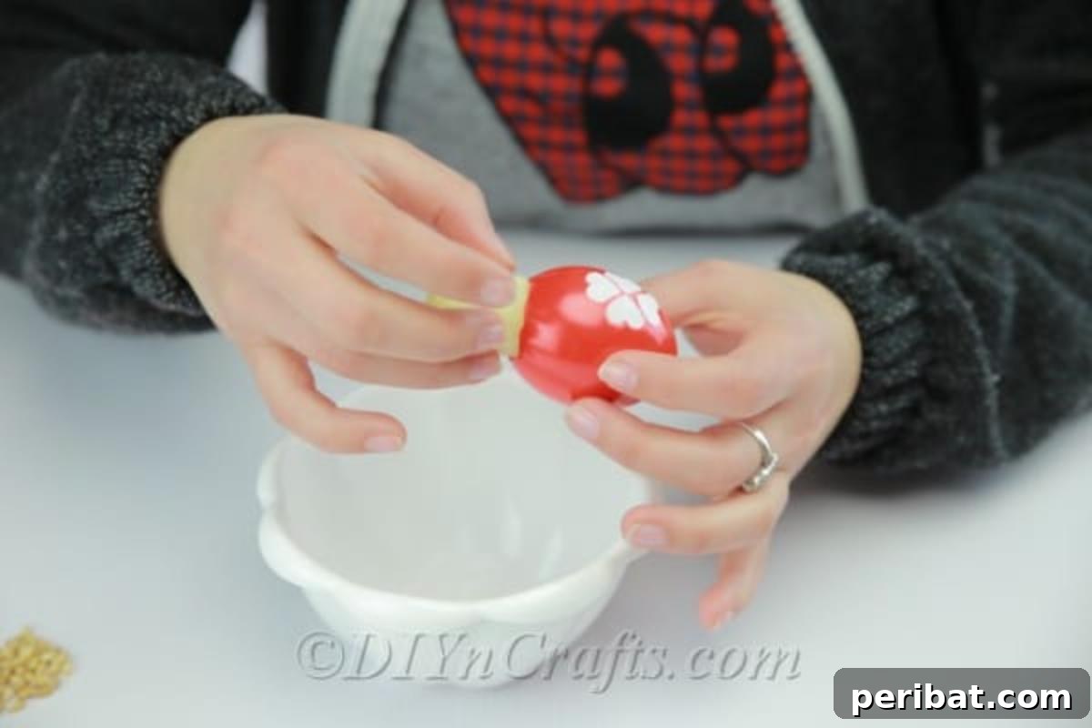 Hatch a DIY Easter Egg Planter 14 Filling the decorated empty eggshell with wet cotton.