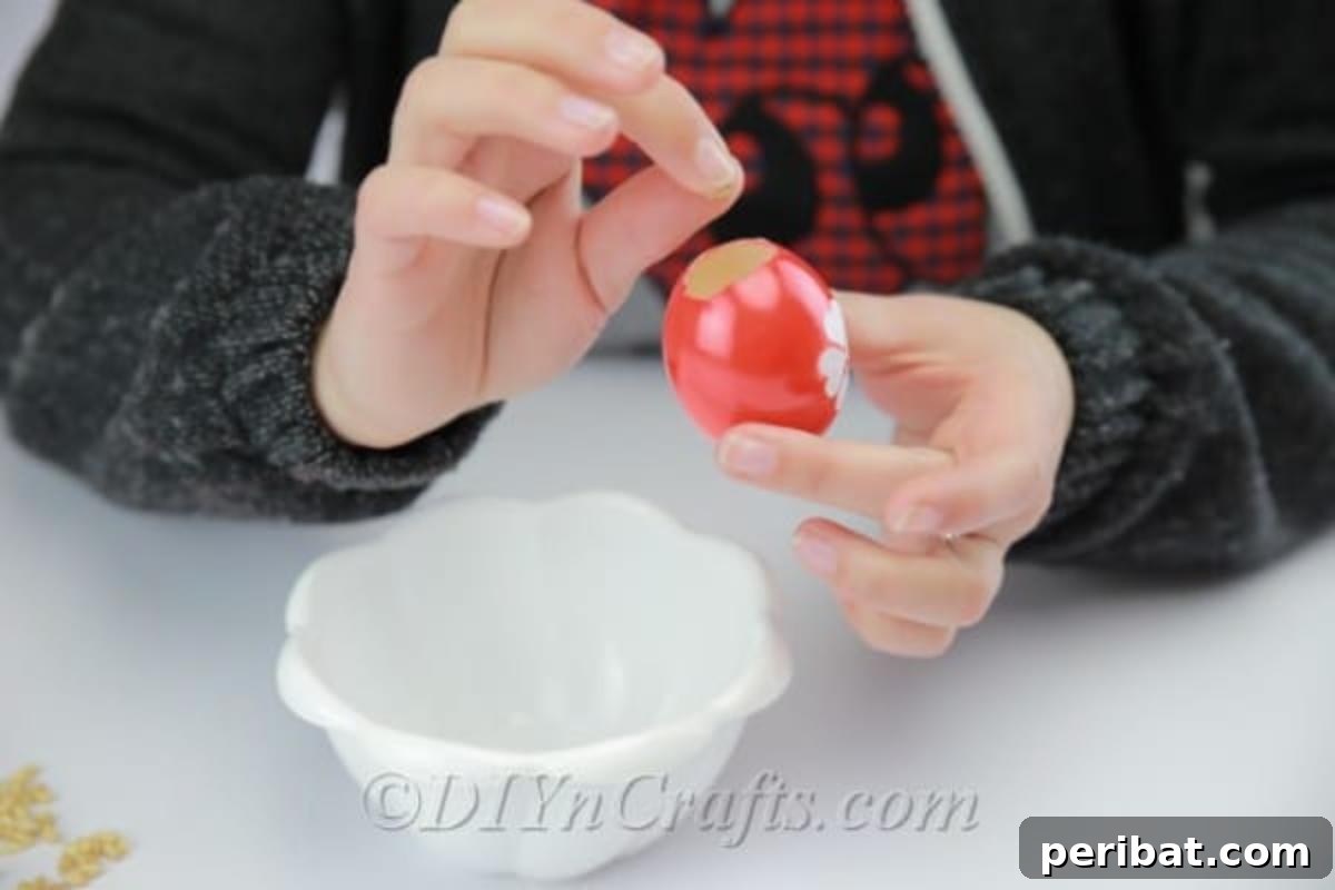 Hatch a DIY Easter Egg Planter 15 Filling the decorated empty eggshell with wet cotton.