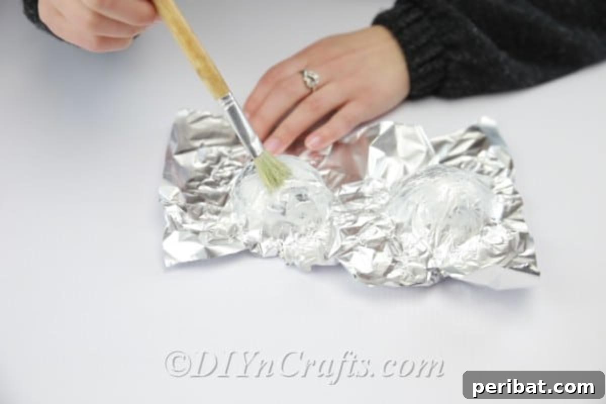 Craft a Realistic Bird Nest for Easter Treats 7 Applying craft glue to the aluminum foil mold for the paper strips