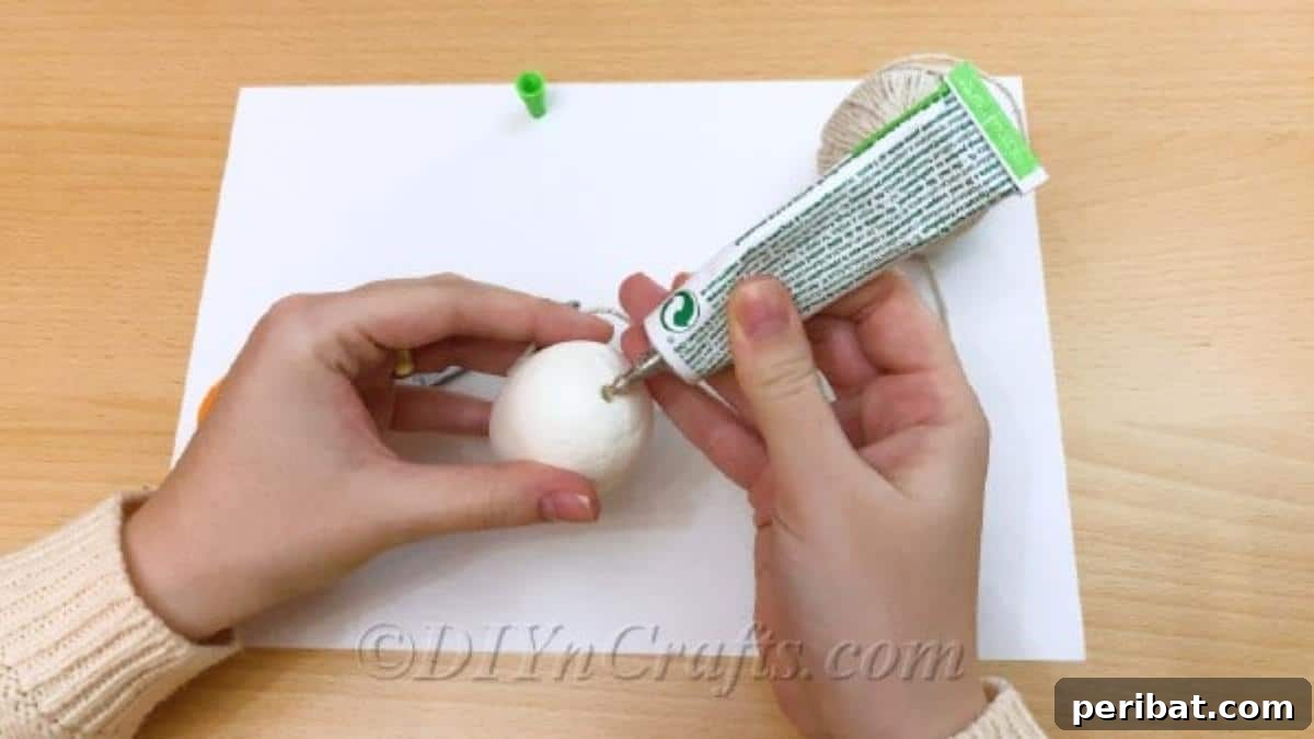 Handcrafted Rustic Glam Easter Eggs 5 Applying a drop of glue to the bottom of the craft egg for the twine