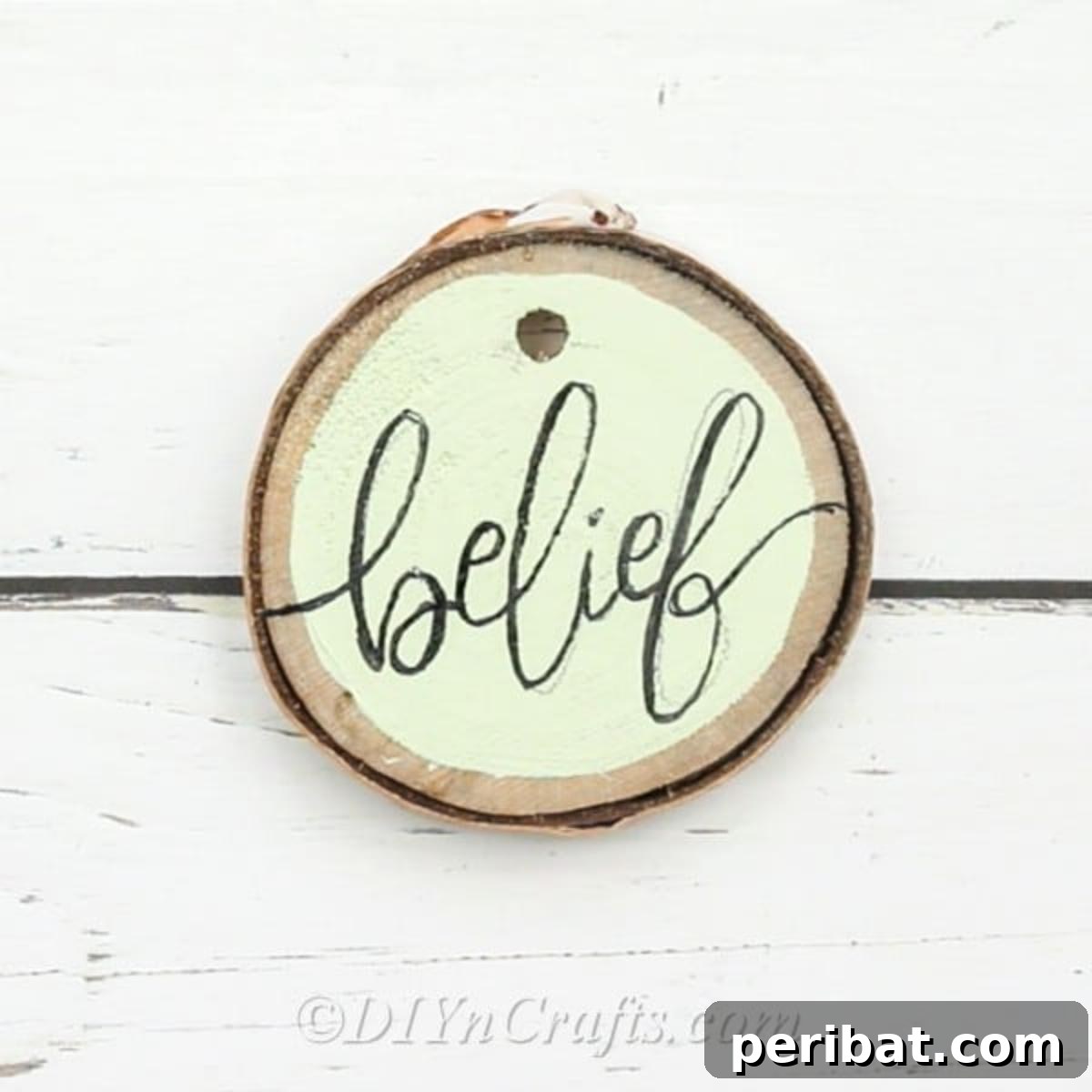 Farmhouse Hand Lettered Wood Slice Easter Decorations 3 Close-up of a hand-lettered wood slice ornament with the word 'Belief' in elegant script
