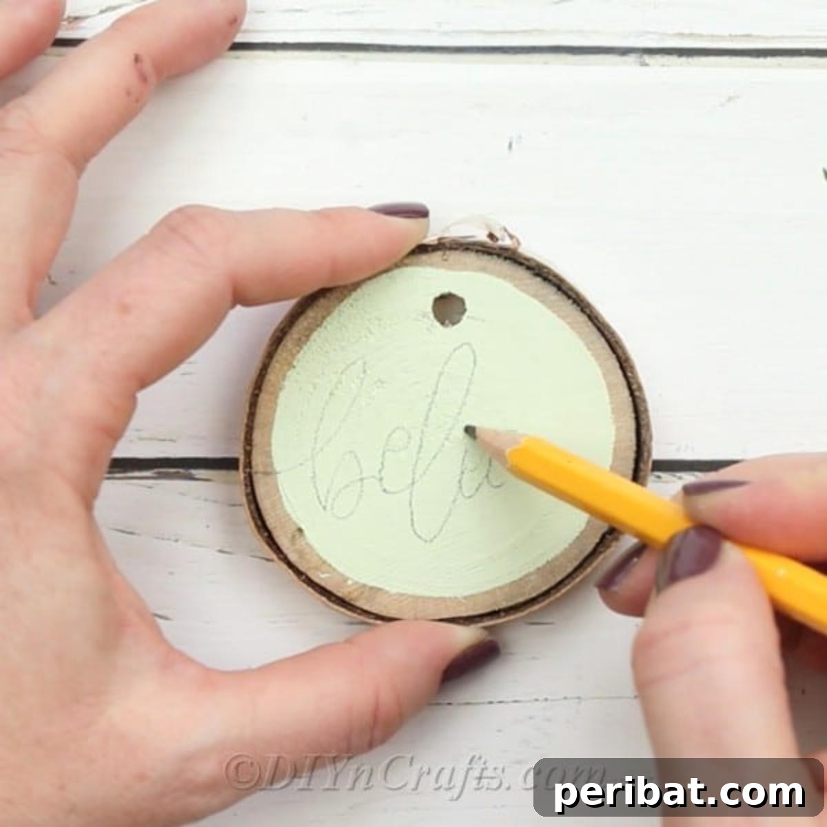 Farmhouse Hand Lettered Wood Slice Easter Decorations 8 Lightly penciling the practiced words onto the painted surface of the wood slices
