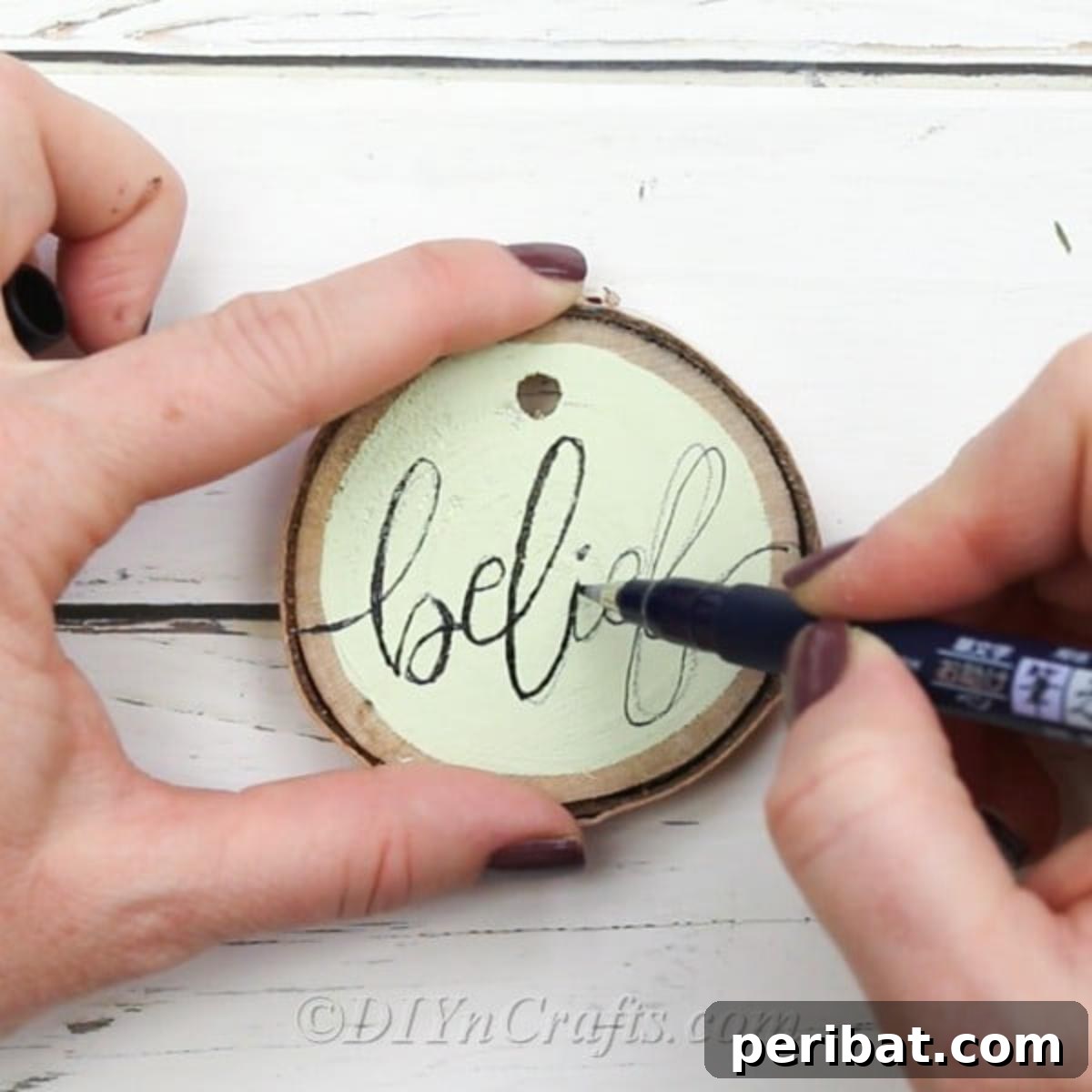 Farmhouse Hand Lettered Wood Slice Easter Decorations 9 Tracing over pencil marks with a black permanent marker or brush pen on wood slices