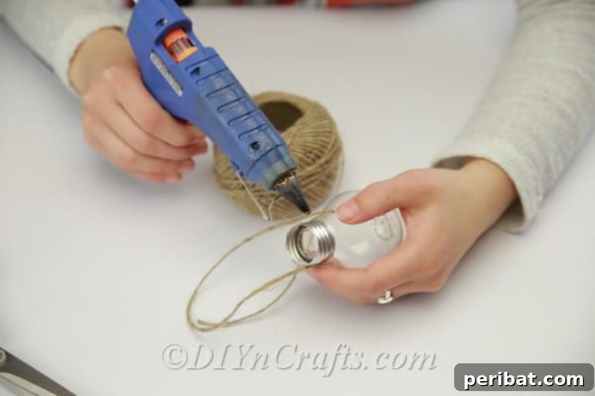 DIY Lightbulb Planter Perfect for Spring 10 Gluing twine to lightbulb bottom