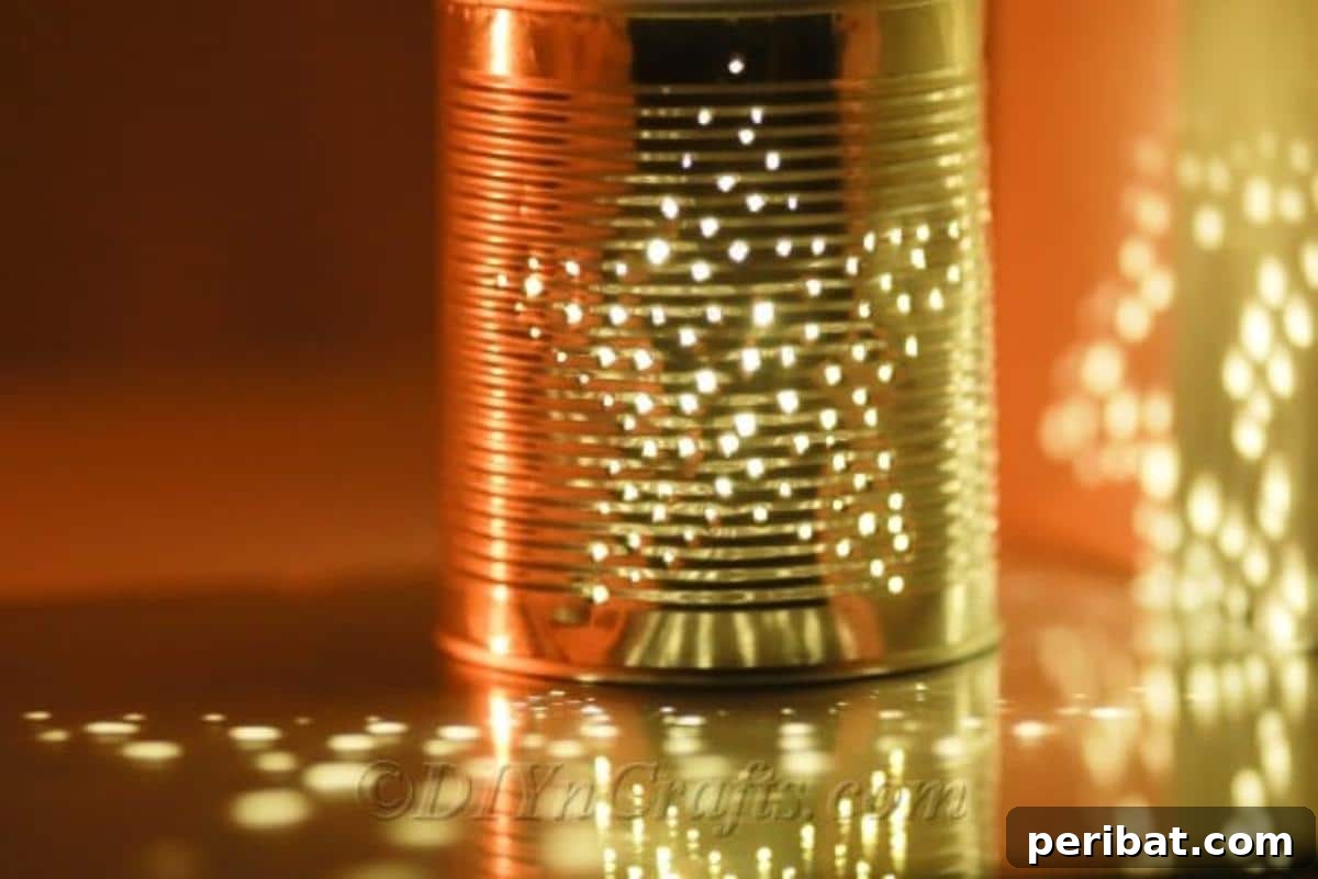 Craft Stunning Lights from Upcycled Tin Cans 12 A lit tin can luminary showcasing its radiant glow and intricate pattern in a low-light setting.