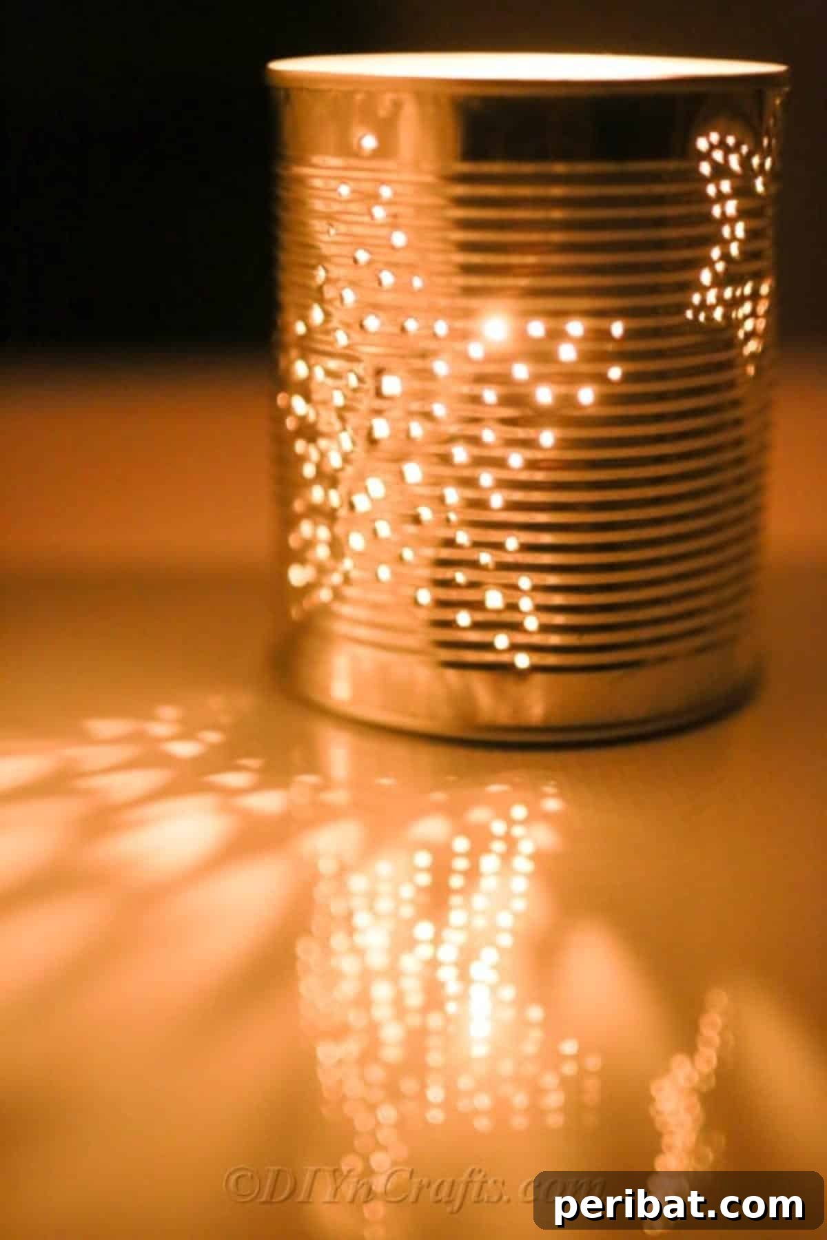 Craft Stunning Lights from Upcycled Tin Cans 5 A beautifully crafted tin can luminary, glowing warmly in an evening garden setting.