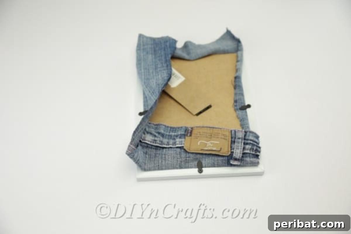Step-by-step guide to cutting away excess material from the denim pocket for a cleaner fit