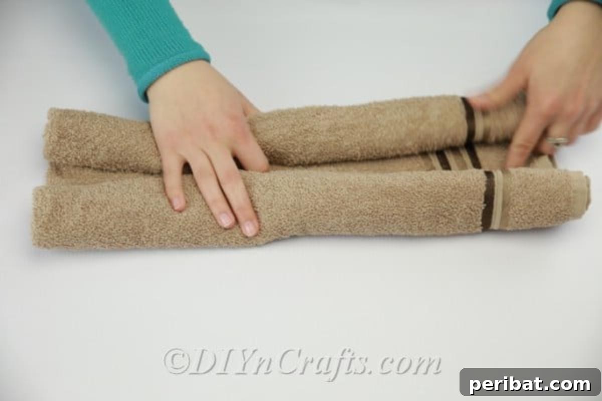 Craft a Cuddly Washcloth Bear 9 Washcloth rolled on both sides, forming the base of the teddy bear