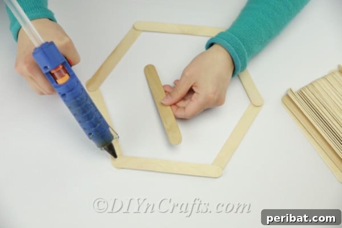 Putting together DIY popsicle stick shelf 