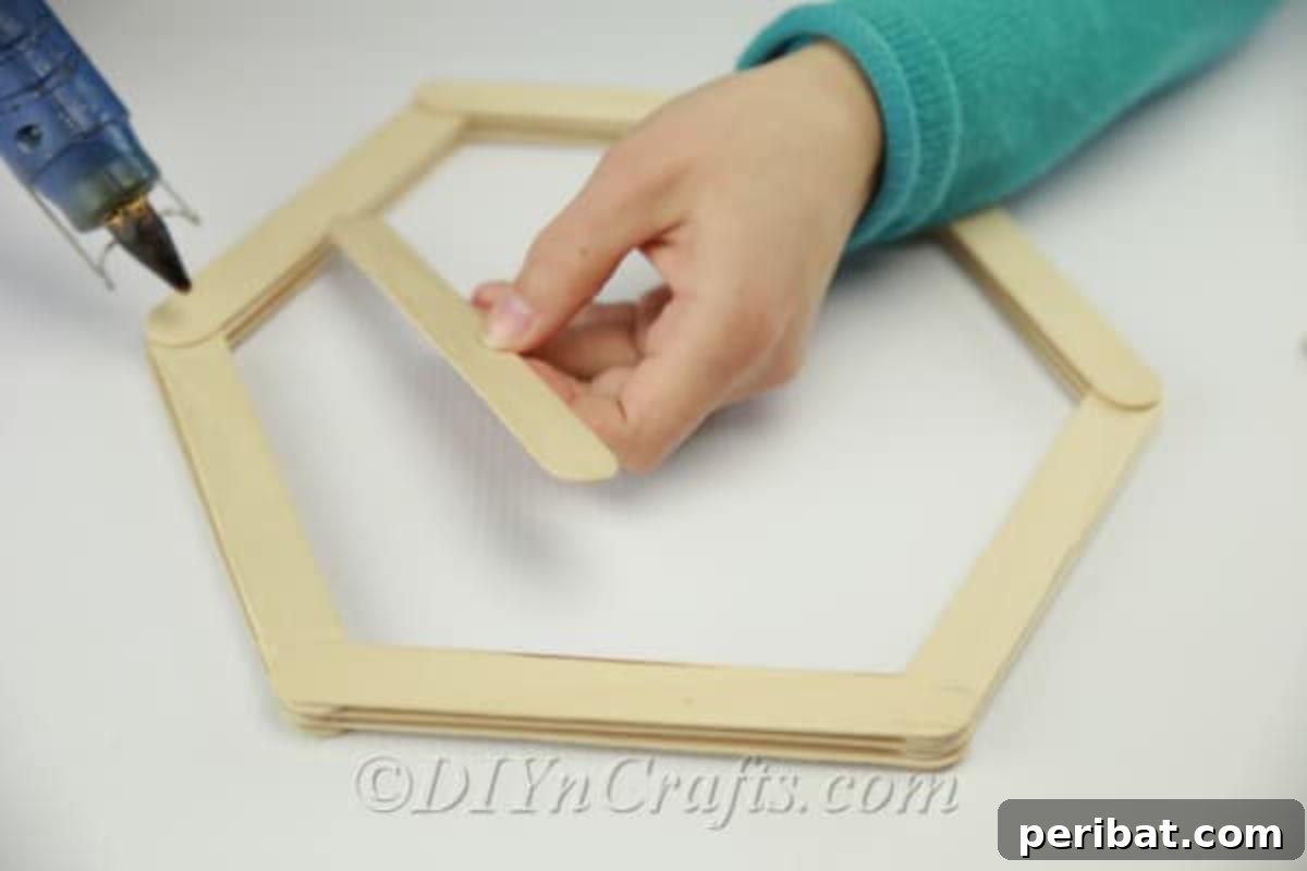 Layering sticks to create the shelf 