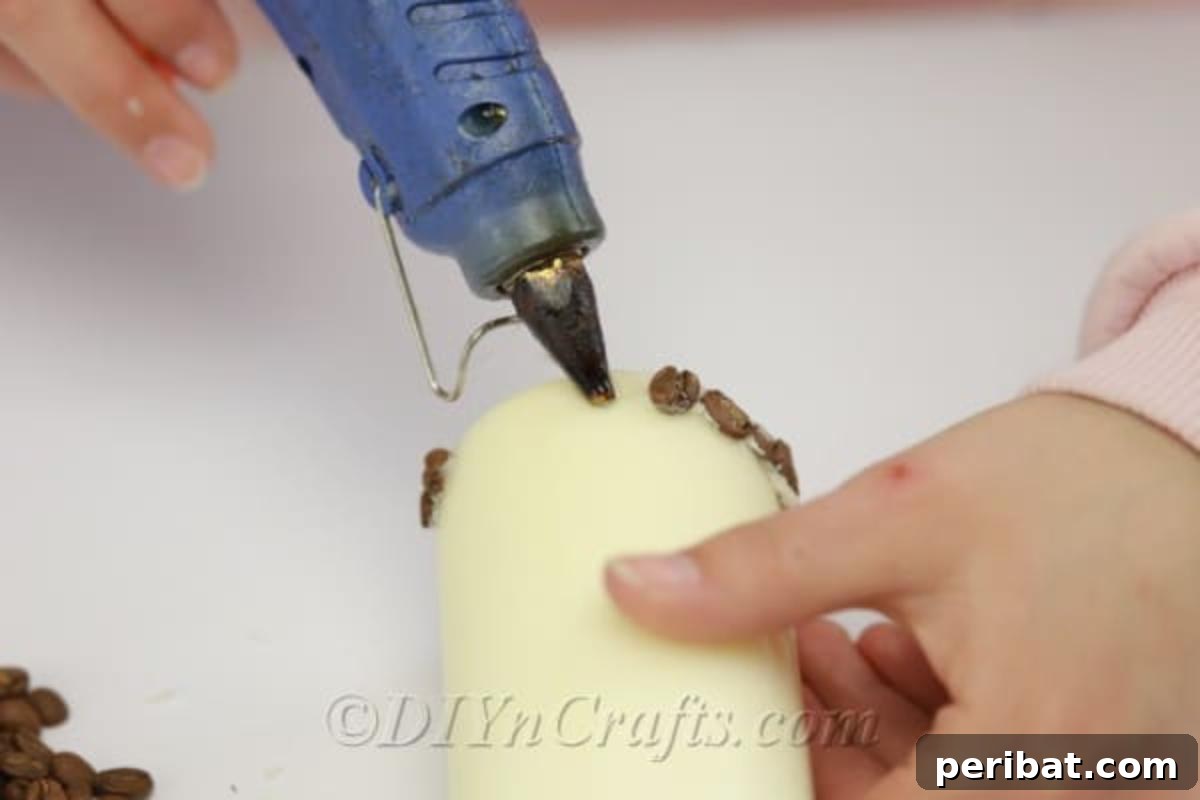 In-progress view of the DIY coffee bean candle creation, highlighting the textured surface and careful placement of each bean.