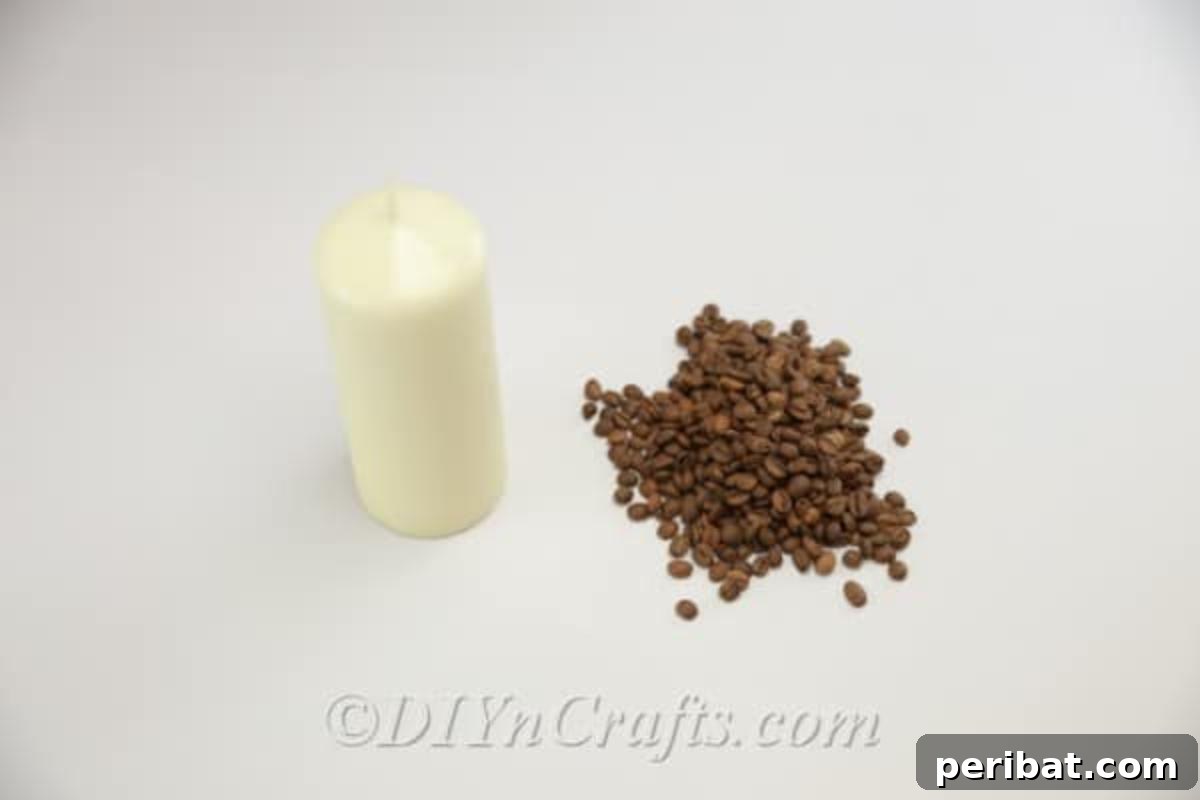 Essential supplies laid out for a DIY coffee candle project, including a pillar candle, coffee beans, and a hot glue gun, ready for crafting.
