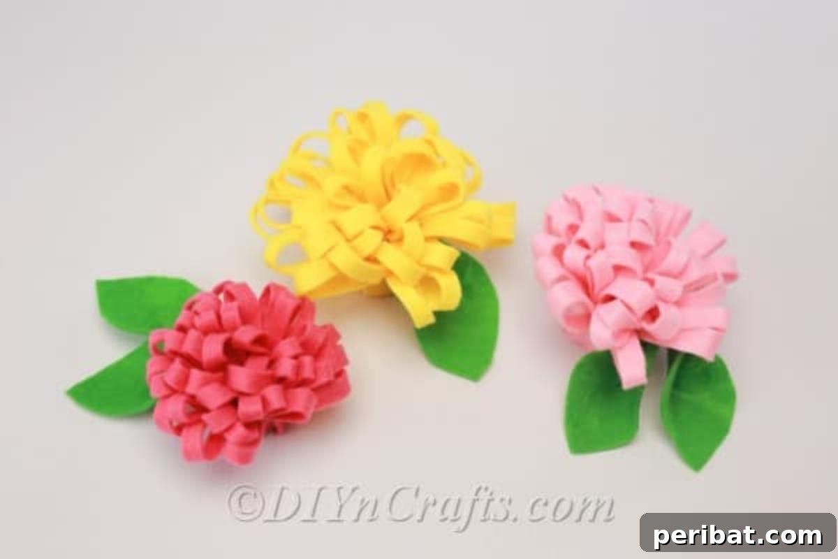 A collection of handmade fabric flowers crafted from felt in various colors.