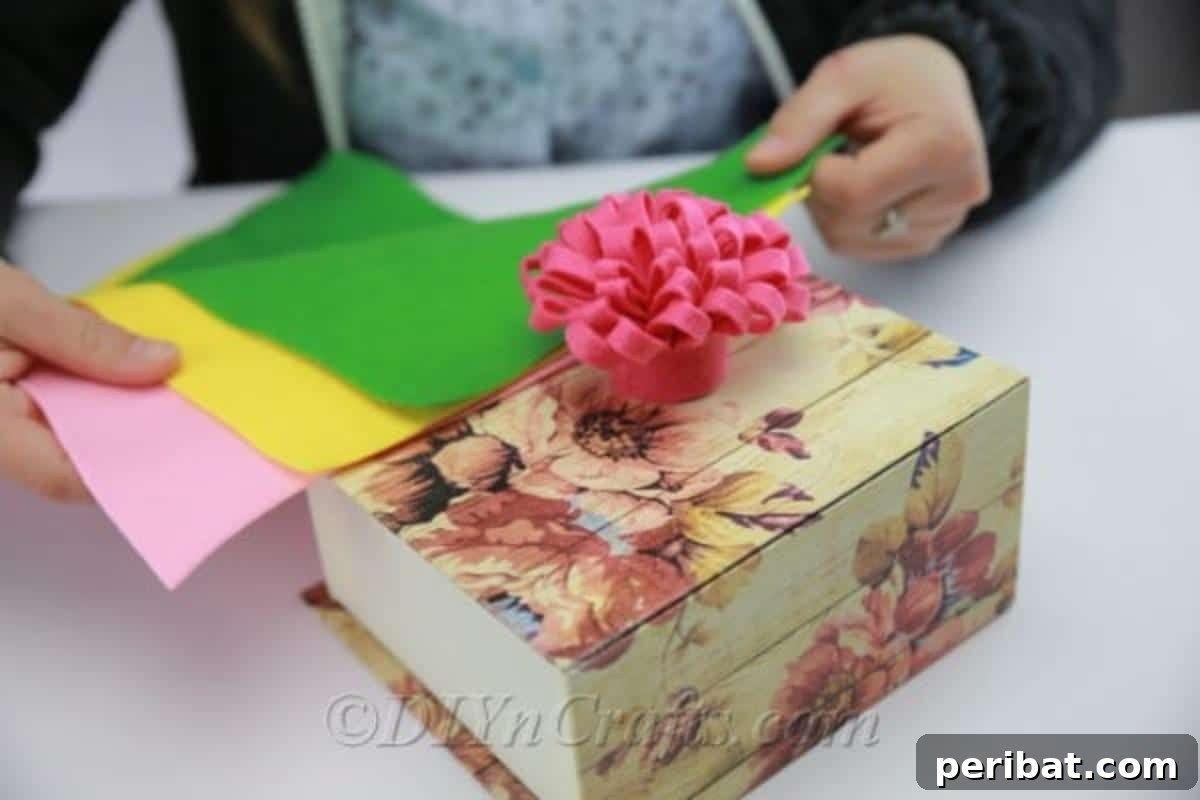 Beautifully crafted DIY fabric flowers used as decorative elements on a book and in a small arrangement.