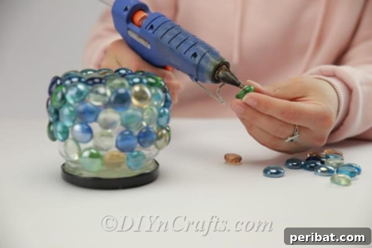 DIY Enchanted Garden Jars 10 Continuing to glue glass stones onto a jar