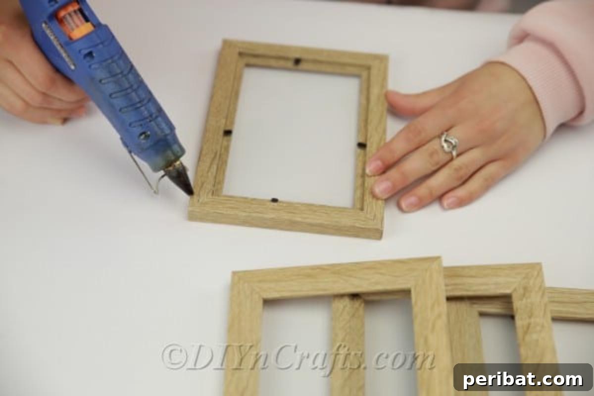 Adding glue to picture frame to hold together side by side