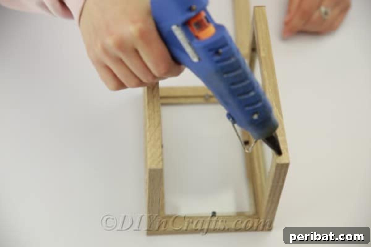 Gluing together second pair of picture frames to create a lantern section
