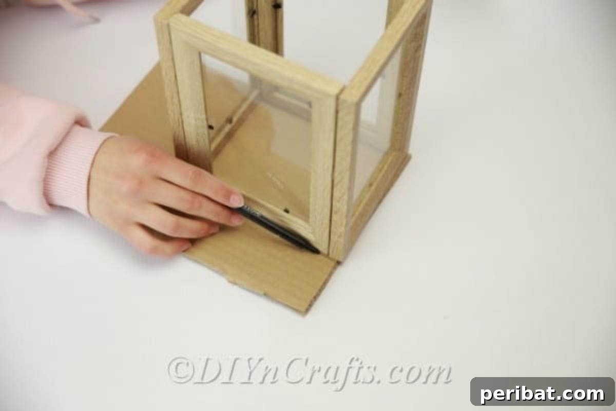 Measuring cardboard to fit the bottom of the lantern frame