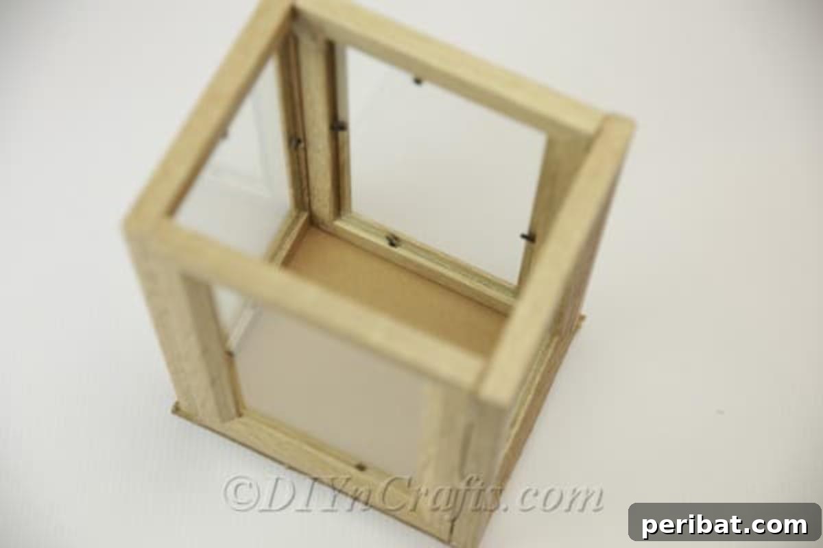 Completed picture frame lantern with cardboard bottom and interior decorations